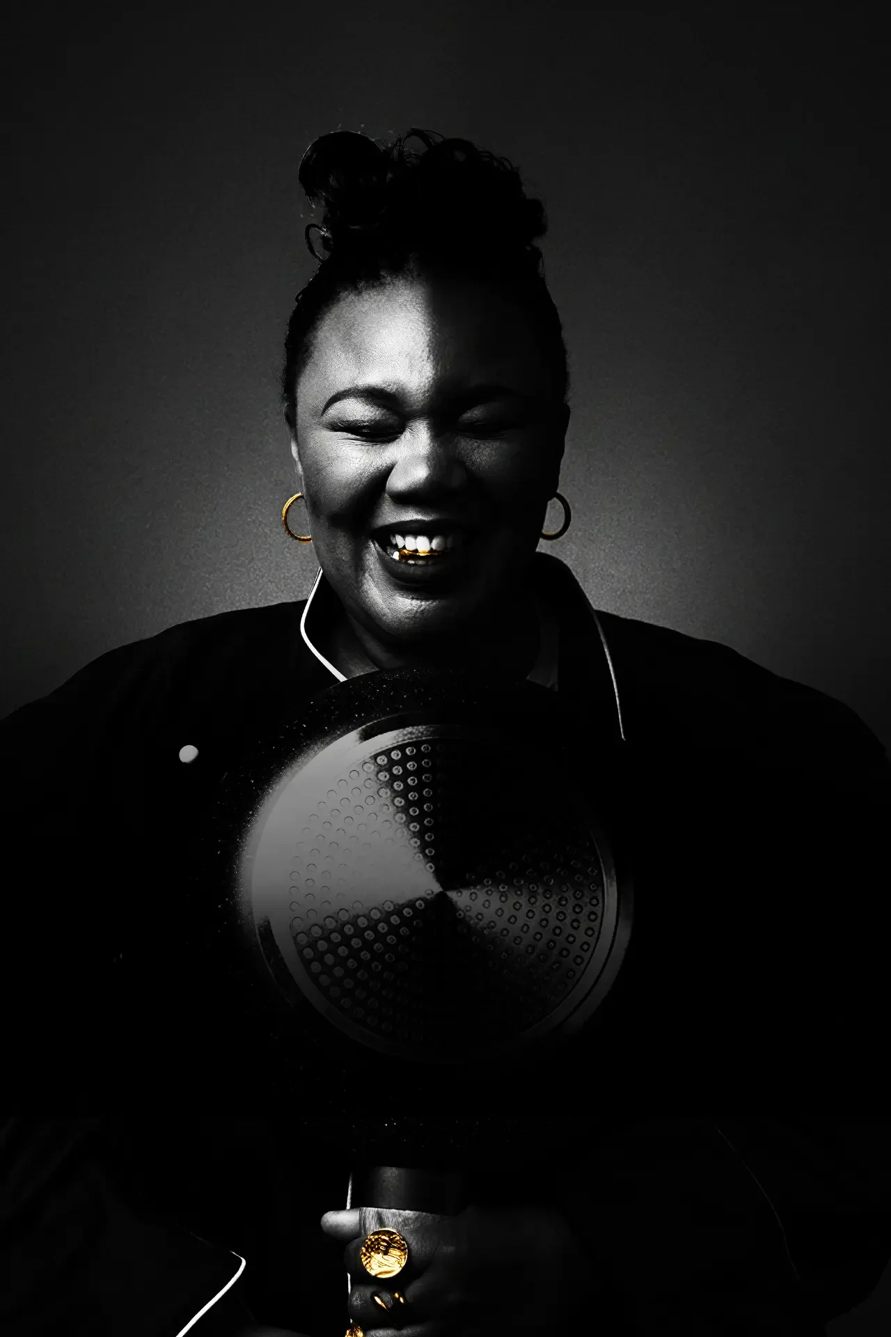 Lady Day laughing, holding a frying pan